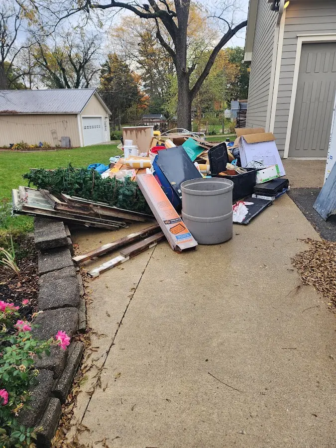 Dumpster being loaded with debris for 12 Yard Dumpster Rental in Breckenridge